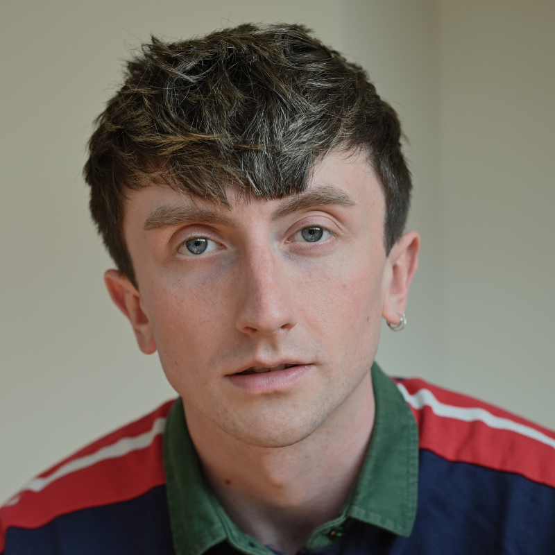 Osian Meilir has short sandy hair and a cool striped jumper