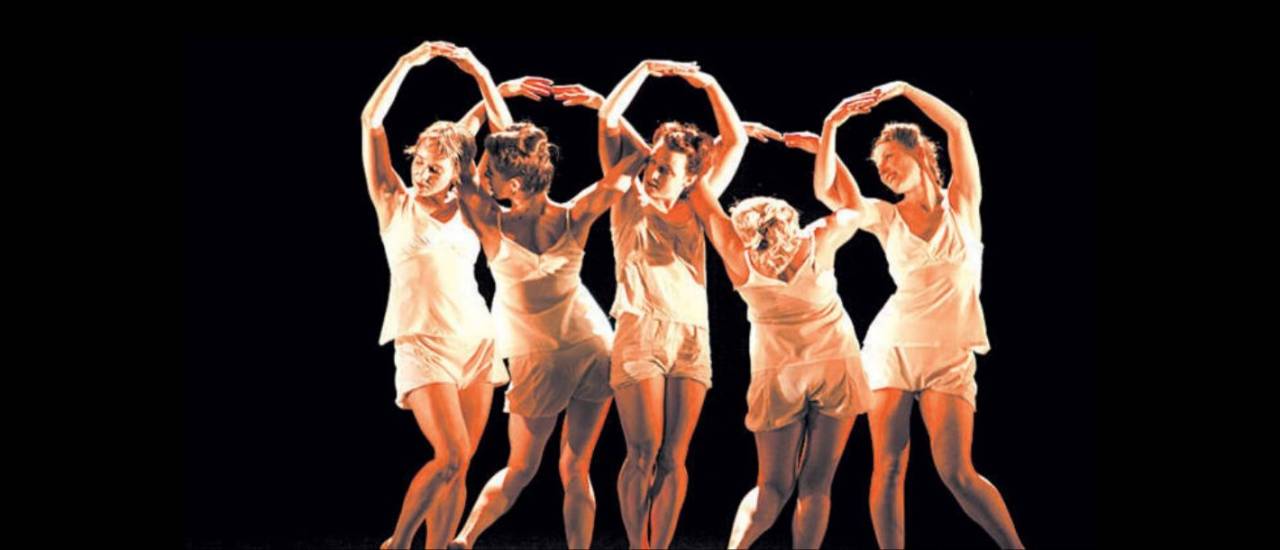 5 dancers in a row with their arms in the air in circles
