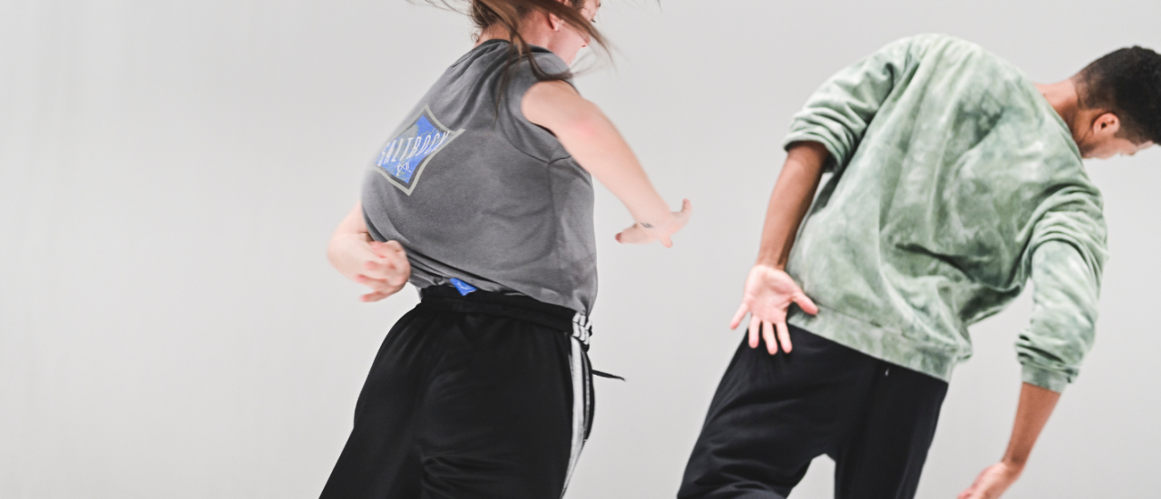 two dancers in a white space